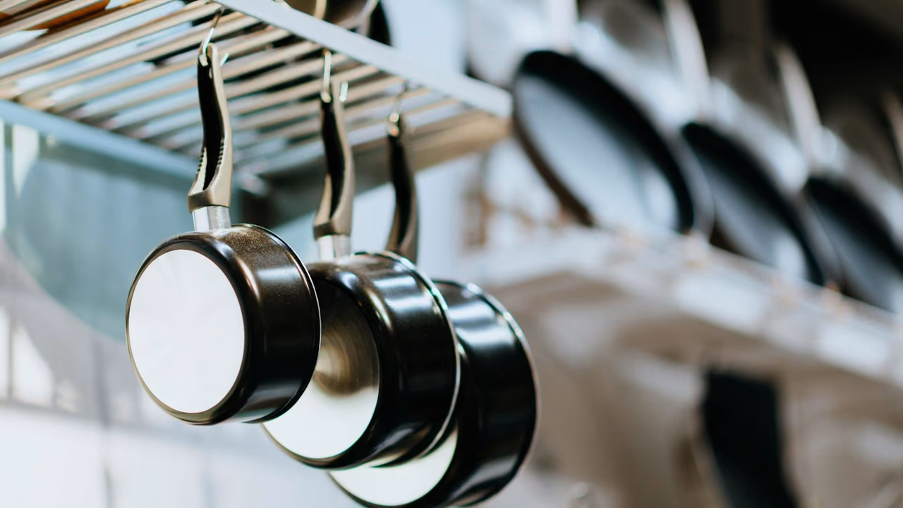 Frying pans hanging from a rack