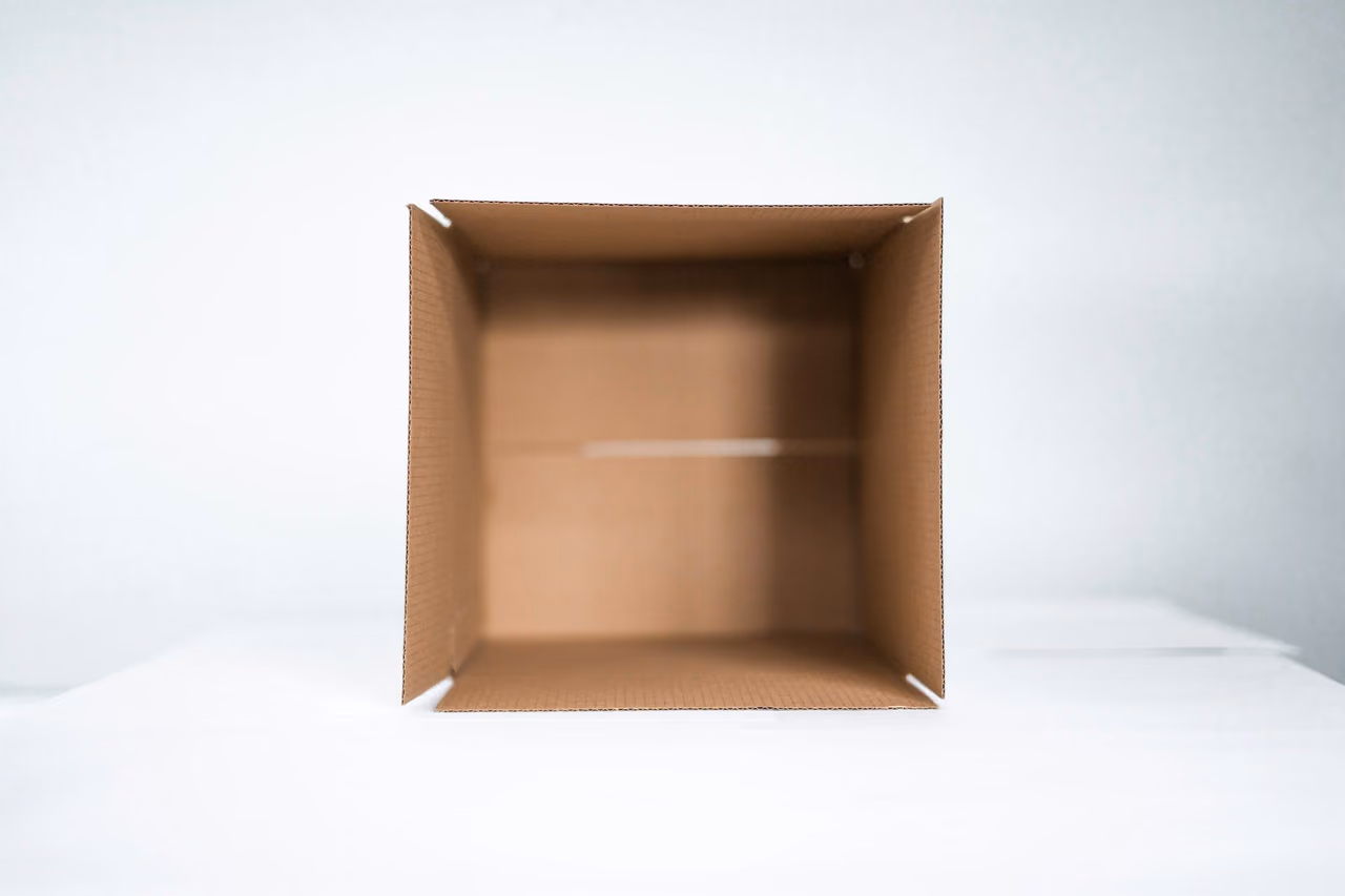 Empty open cardboard shipping box seen from above on a white background